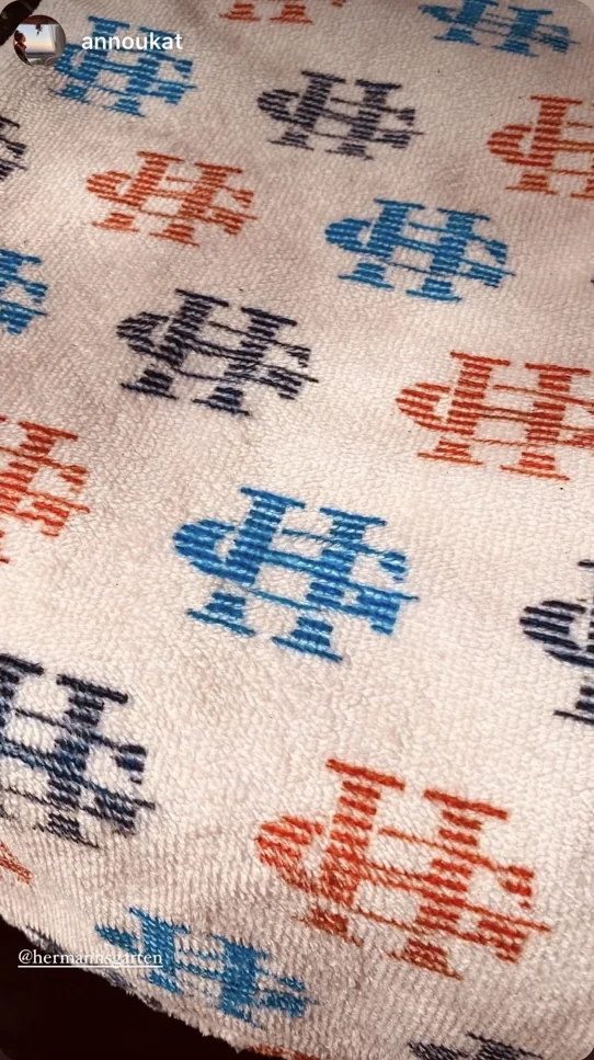 Branded cream cloth with multicolored HG monograms